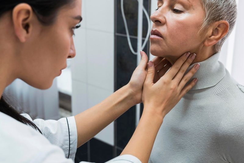 doctor-checking-patient-s-neck_23-2148757366
